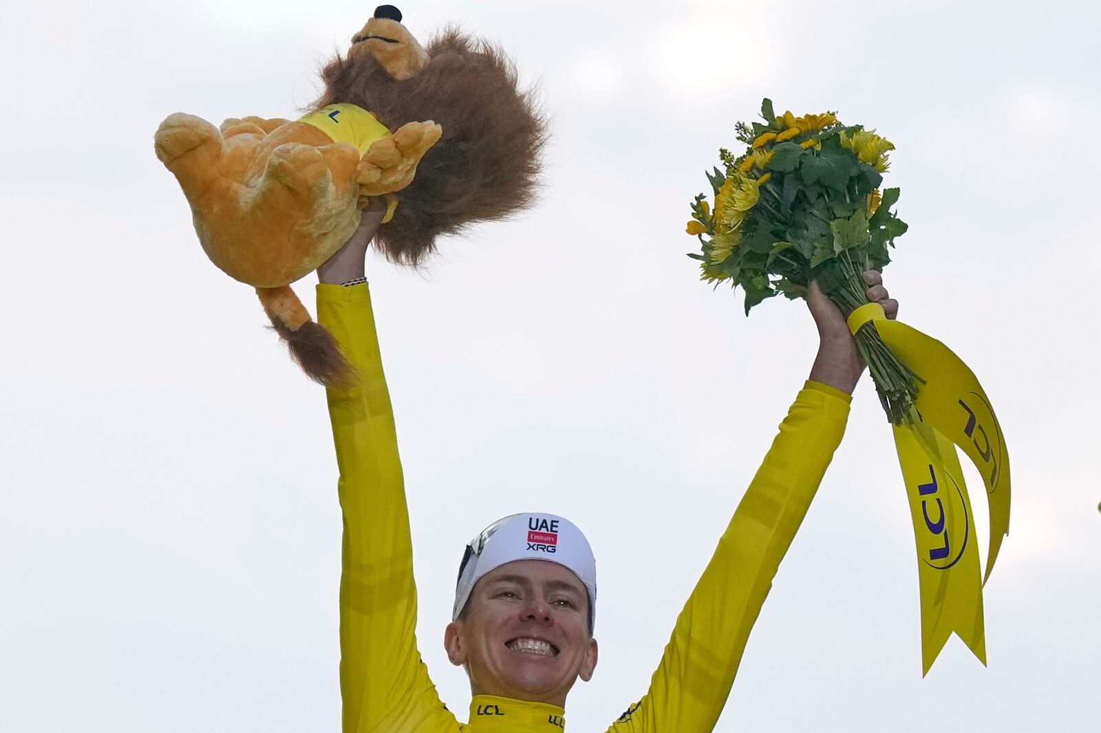 Tour de France winner Tadej Pogacar of Slovenia celebrates on the podium after the twenty-first stage of the Tour de France cycling race over 132.3 kilometers (82.1 miles) with start in Mantes-la-Ville and finish on the Champs-Elysees in Paris, France, Sunday, July 27, 2025. (AP Photo/Mosa'ab Elshamy)