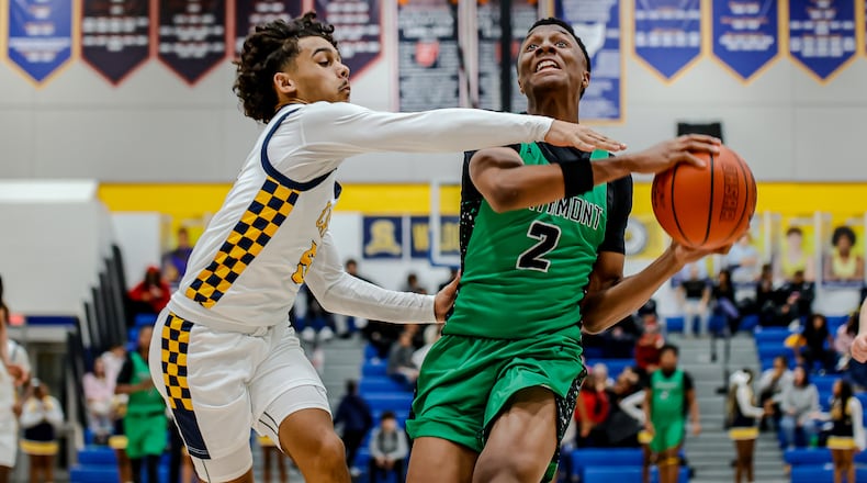 Northmont High School senior Chimson Ibe drives past Springfield senior Charles Cunningham during their game on Friday night at Springfield High School. The Thunderbolts won 68-60. MICHAEL COOPER / STAFF