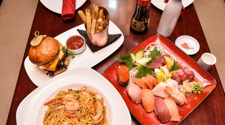 The Sushi and Sashimi sampler, The Woodford burger and fries, and Shrimp Lo Mein are displayed Wednesday, Jan. 17 at Basil 1791 that is now open on High Street in Hamilton. Basil 1791 offers a variety of dishes from sushi to traditional American fare. NICK GRAHAM/STAFF