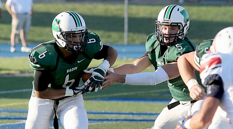 Badin halfback Lavassa Martin takes a handoff from quarterback Andrew Walsh during their game against Talawanda at Virgil Schwarm Stadium in Hamilton on Sept. 3, 2016. The host Rams won 38-7. CONTRIBUTED PHOTO BY E.L. HUBBARD
