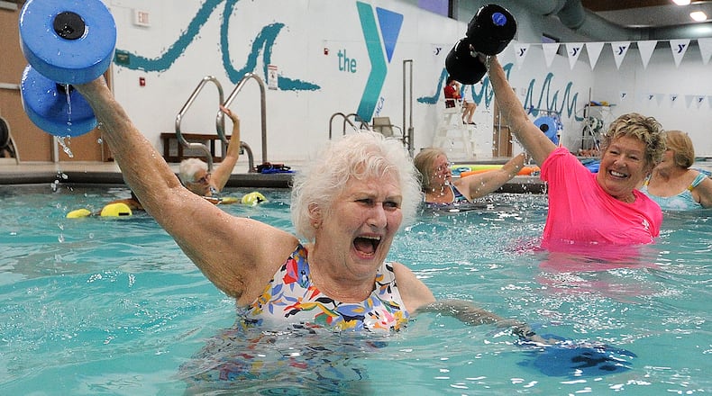 Marilyn Specht, 84, left, works with her instructor Sandy Bakos, during a water exercise class Tuesday Feb. 29, 2023.
Specht goes 5 times a week to the Kleptz YMCA in Englewood. MARSHALL GORBY\STAFF