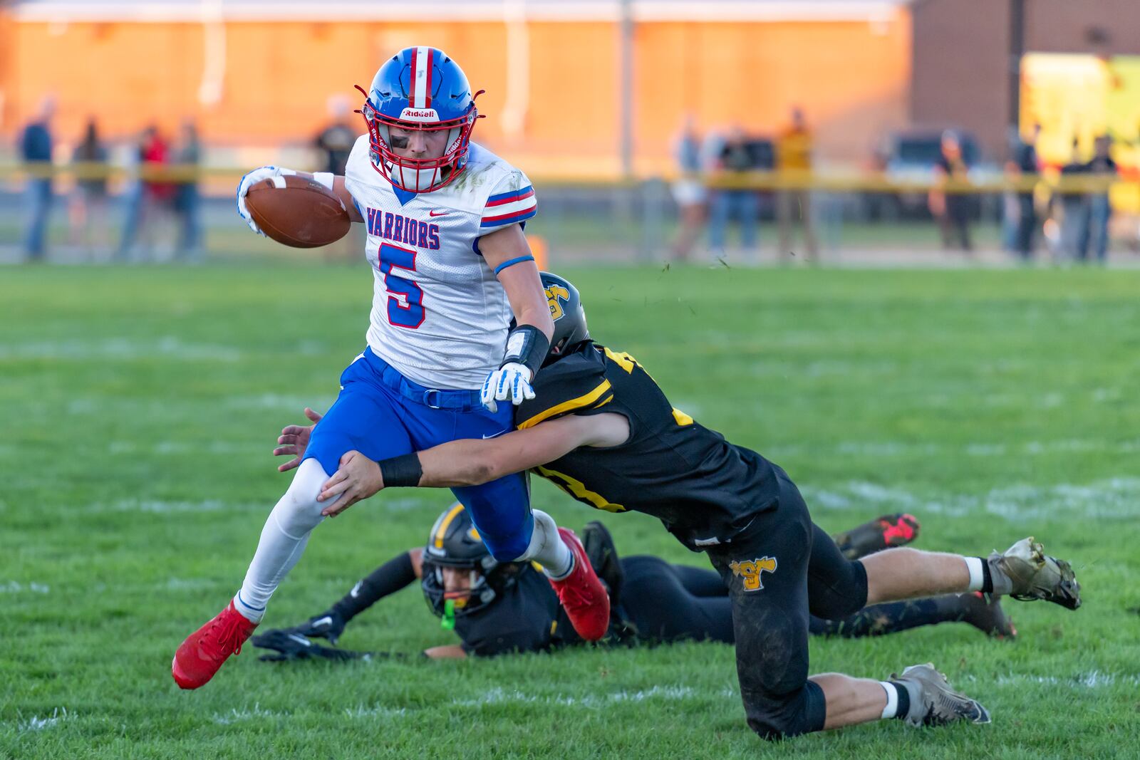 Northwestern High School senior quarterback Ried Smith runs through a Shawnee defender on Friday, Sept. 26 in Springfield Twp. The Warriors won 28-13. RODNEY GETZ / CONTRIBUTED PHOTO