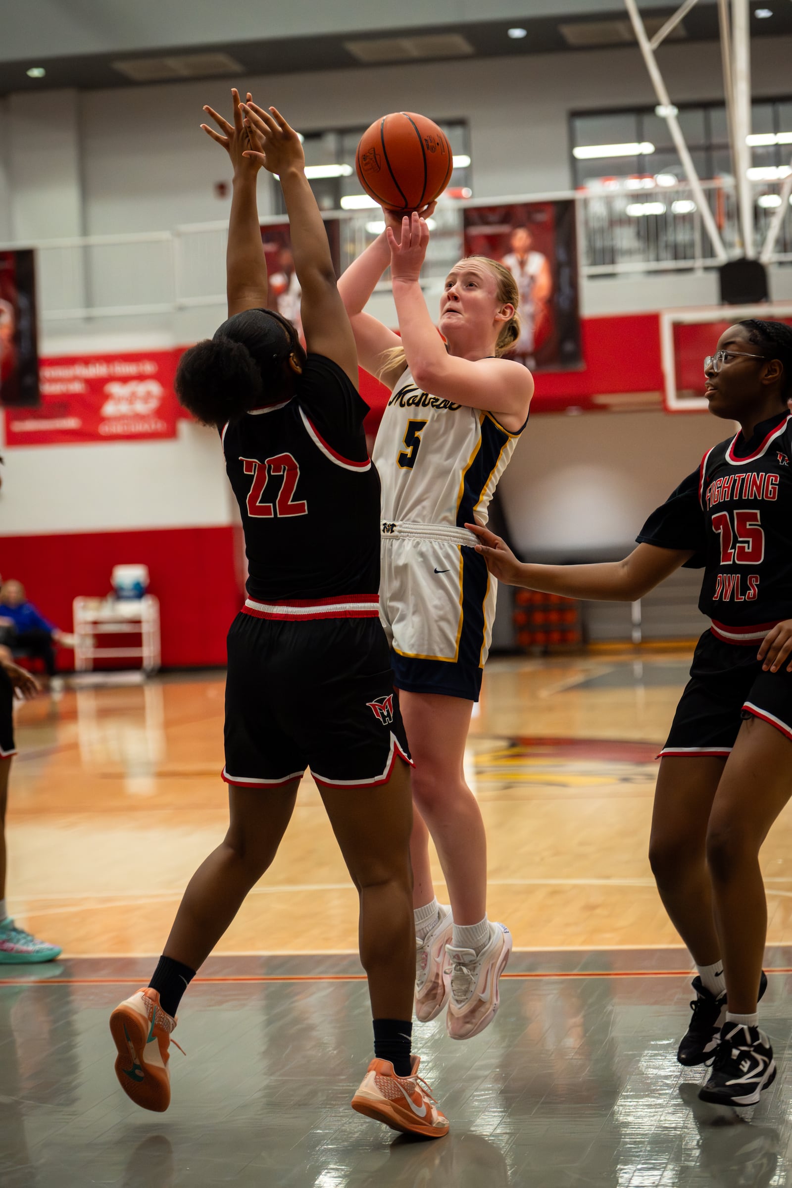 Monroe’s Emma Adolph puts up a shot during her Division III tournament game against Mount Healthy on Thursday night at Princeton. AJ FULLAM / CONTRIBUTED