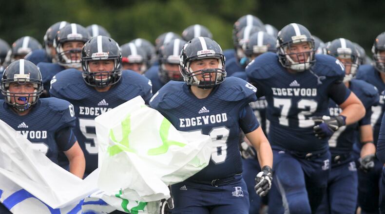 Edgewood defensive lineman Justin Pottorf (58), leads his team onto the field for their home game against Badin, Friday, Sept. 12, 2014. GREG LYNCH / STAFF