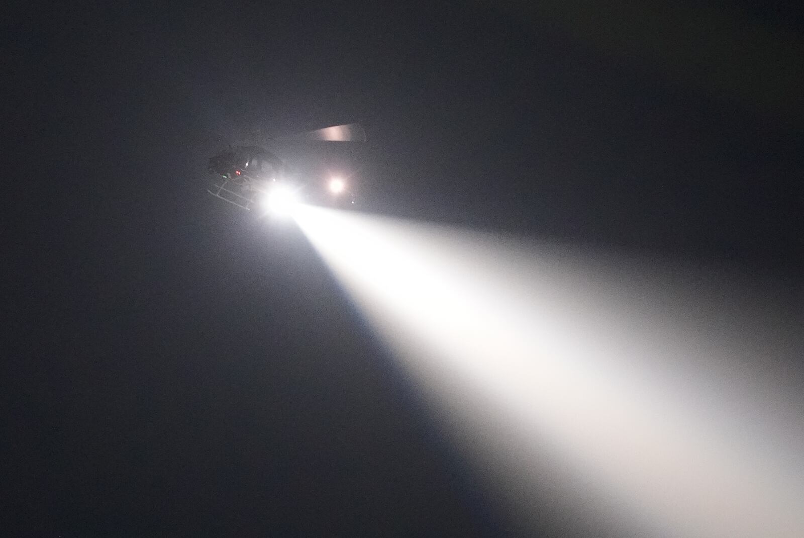 A police helicopter pursues a fugitive that escaped from a New Orleans jail, on North Galvez street Tuesday, May 20, 2025, in New Orleans. (AP Photo/Gerald Herbert)