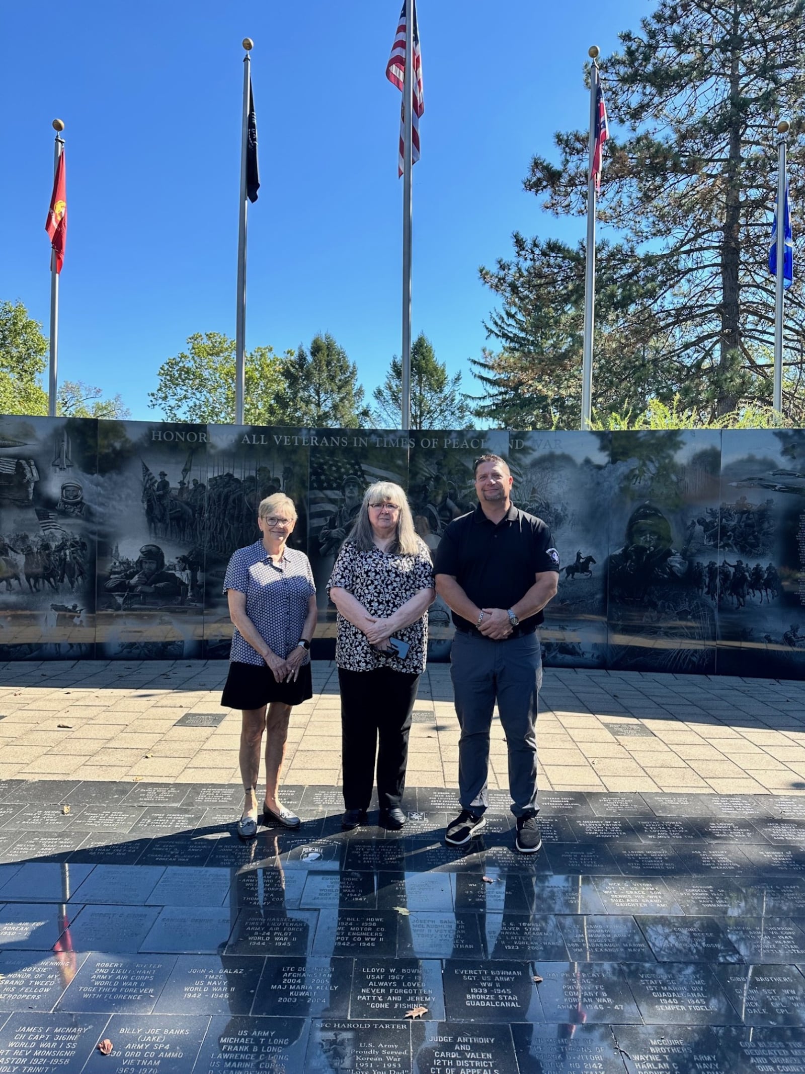 Committee members Lisa George and Deb Morrison Snider along with chair Neil Douglas are seen at the Middletown Veterans Memorial. JEFFREY DIVER/CONTRIBUTED