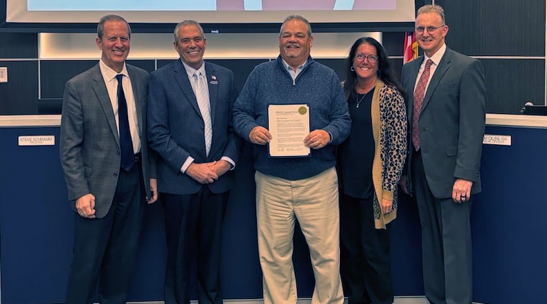 Liberty Twp.’s retiring services director Rick Plummer received a proclamation of appreciation from trustees, from left, Steve Schramm, Tom Farrell, Plummer, Caroline McKinney (township administrator) and Todd Minniear. LIBERTY TWP./CONTRIBUTED
