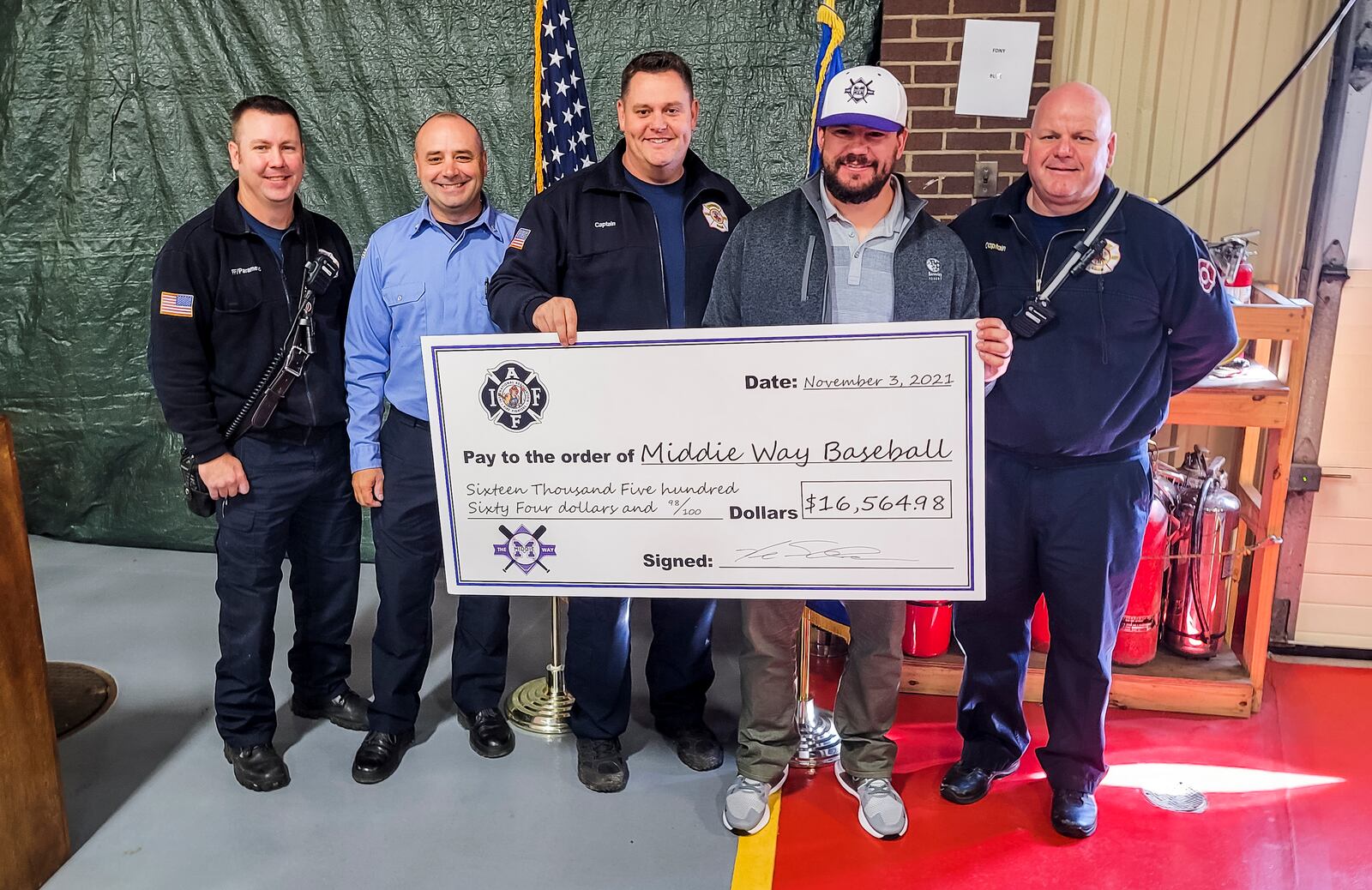 The Middletown Firefighters Association made a donation of over $16,000 to The Middie Way Baseball represented by Kyle Schwarber, an organization focused on helping area youth learn the game of baseball, during a ceremony Wednesday, Nov. 3, 2021 at the Middletown Division of Fire headquarters. NICK GRAHAM / STAFF