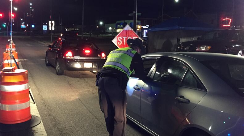 An Ohio State Highway Patrol trooper checks a driver during an OVI checkpoint at University Boulevard and First Avenue in Middletown on Jan. 17, 2020. The checkpoint was the latest organized by the Butler County OVI Task Force. The Middletown checkpoint was conducted by Middletown police, the highway patrol, and Butler County Sheriff’s deputies. ED RICHTER/STAFF