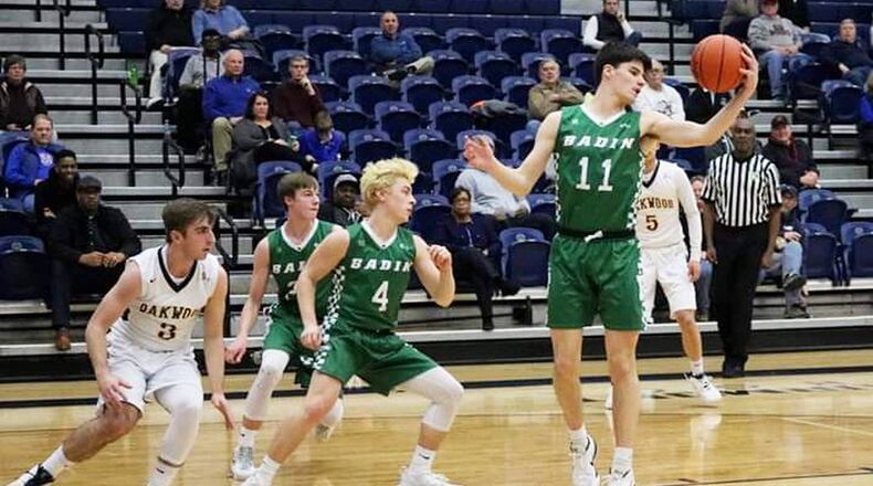 Badin’s Spencer Giesting (11) grabs a rebound in front of teammate Easton Scowden (4) and Oakwood’s Jacob Sargent (3) on Tuesday night at Fairmont’s Trent Arena. Badin won the Division II sectional game 65-55. CONTRIBUTED PHOTO BY TERRI ADAMS