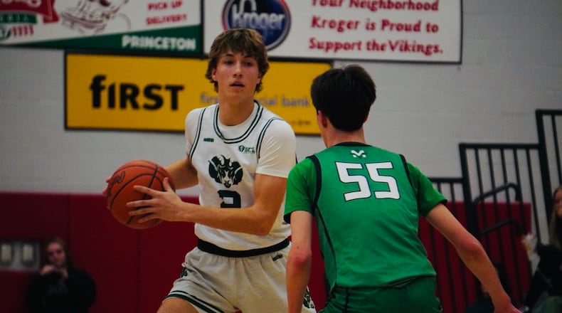 Badin senior Carson Lowe looks for a passing lane as McNicholas sophomore Grant Walters (55) supplied the defense. Chris Vogt/CONTRIBUTED