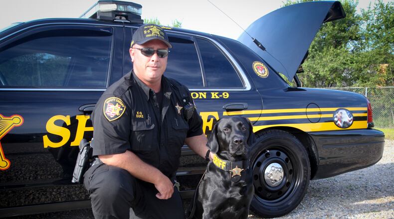 Butler County Sheriff’s Office canine officer Jeff Duke and his dog, Jackson. GREG LYNCH / STAFF