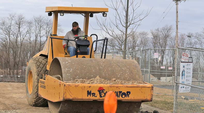A worker drives an roller at the construction site of the new QuickTrip location near the intersection of South Limestone Street and Leffel Lane Friday, March 7, 2025. The Ohio Department of Medicaid submitted a request to the U.S. Centers of Medicare and Medicaid Services to implement work requirements for certain Medicaid enrollees in the expansion group as the federal government weighs significant cuts to the program nationally, both of which could result in people losing their health insurance. BILL LACKEY/STAFF