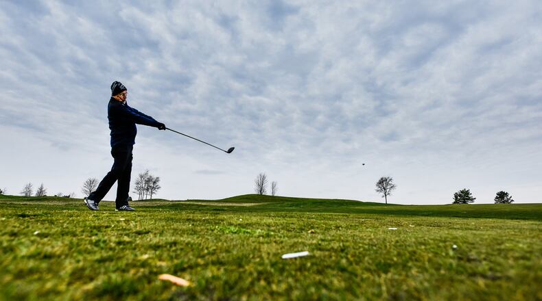 Tom Brandner tees off as he plays a round of golf at Indian Ridge Golf Club Tuesday, March 24, 2020 in Hanover Township. The golf course was not officially open to the public Tuesday but some members have been utilizing the course. When they do open they will be trying to minimize the spread of coronavirus by only allowing one person per cart and closing the concession area. NICK GRAHAM / STAFF