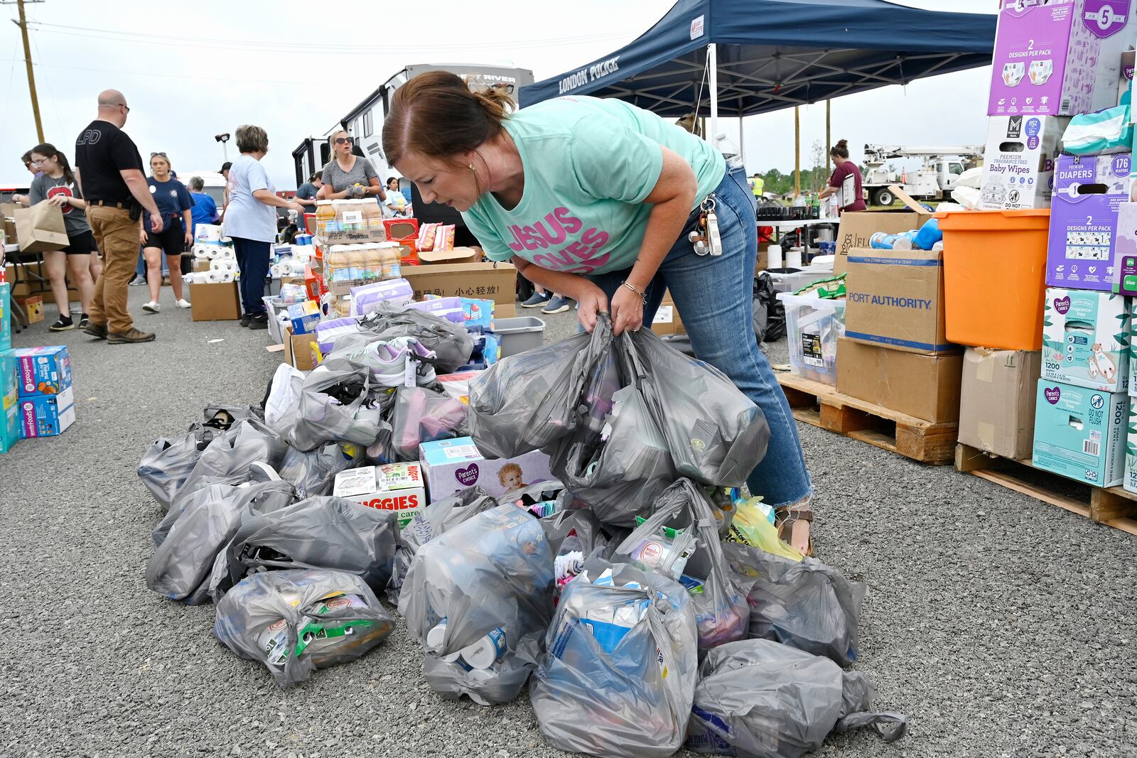 A volunteer sorts through supplies for distribution to families affected by severe storms at the London-Corbin Airport in London, Ky., Monday, May 19, 2025. (AP Photo/Timothy D. Easley)