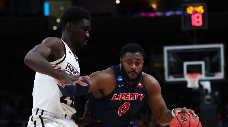 SAN JOSE, CALIFORNIA - MARCH 22: Myo Baxter-Bell of the Liberty Flames drives with the ball against Abdul Ado #24 of the Mississippi State Bulldogs during their game in the First Round of the NCAA Basketball Tournament at SAP Center on March 22, 2019 in San Jose, California. (Photo by Yong Teck Lim/Getty Images)