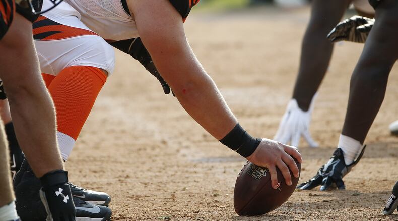 Cincinnati Bengals center Russell Bodine (61) stands over the ball at the line of scrimmage during the second half of an NFL football game against the Oakland Raiders in Oakland, Calif., Sunday, Sept. 13, 2015. (AP Photo/Tony Avelar)