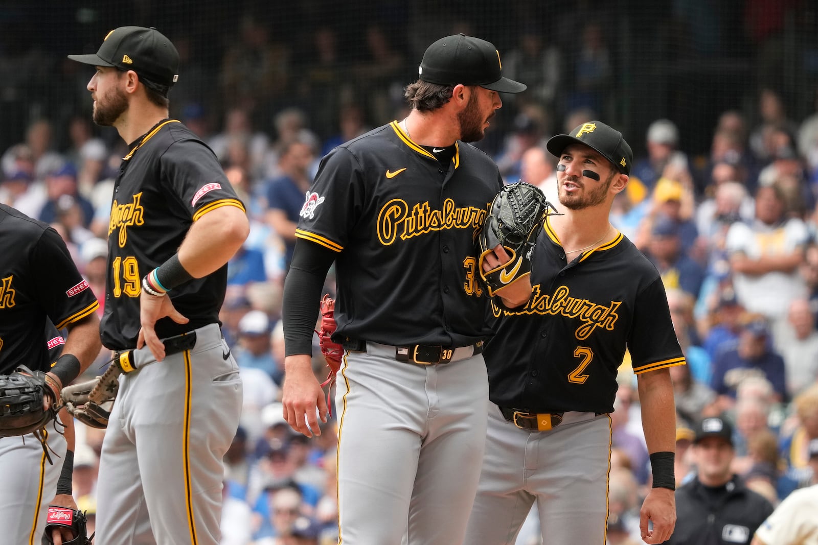 Pittsburgh Pirates, from left, shortstop Jared Triolo, pitcher Paul Skenes and first baseman Spencer Horwitz meet at the mound during the second inning of a baseball game against the Milwaukee Brewers, Wednesday, June 25, 2025, in Milwaukee. (AP Photo/Kayla Wolf)