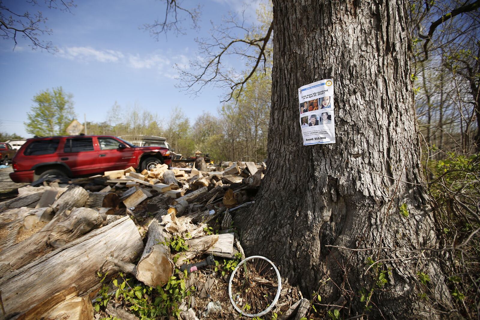 A reward poster for information about the Rhoden murders hangs in a tree outside the home of Leonard Manley, whose daughter Dana Rhoden, 37, was one of the eight victims in Pike County on April 22, 2016. The case remains unsolved. TY GREENLEES / STAFF
