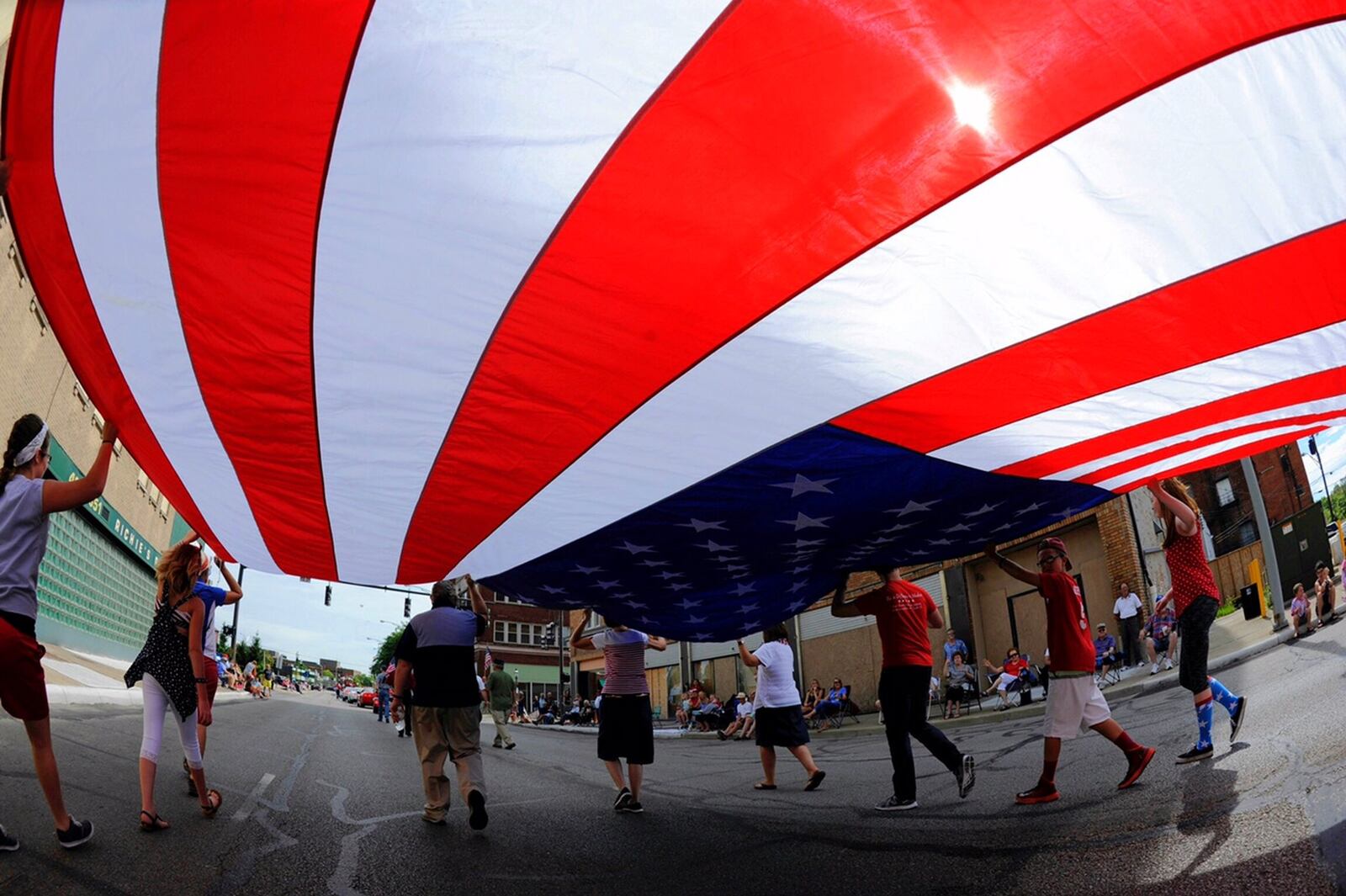 A group carries a large American flag during the Broad Street Blast Independence Day parade in 2016 in Middletown. NICK GRAHAM/STAFF