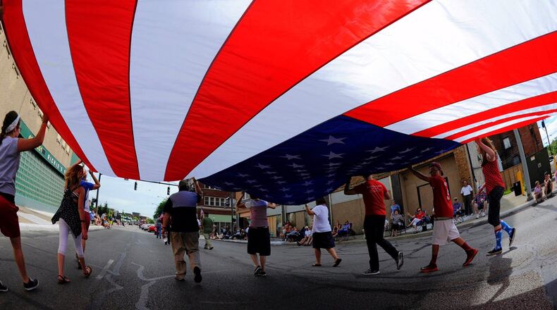 A group carries a large American flag during the Broad Street Blast Independence Day parade in 2016 in Middletown. NICK GRAHAM/STAFF