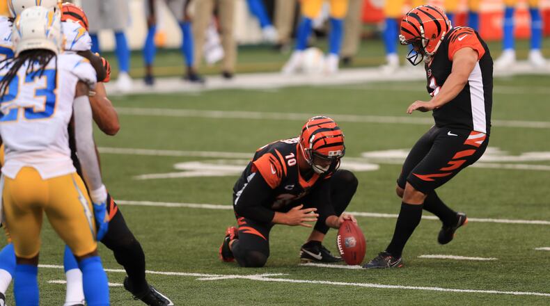Cincinnati Bengals kicker Randy Bullock (4) misses a field goal out of the hold of Kevin Huber (10) during the second half of an NFL football game against the Los Angeles Chargers, Sunday, Sept. 13, 2020, in Cincinnati. The field goal would have tied the game. Los Angeles Chargers won 16-13. (AP Photo/Aaron Doster)