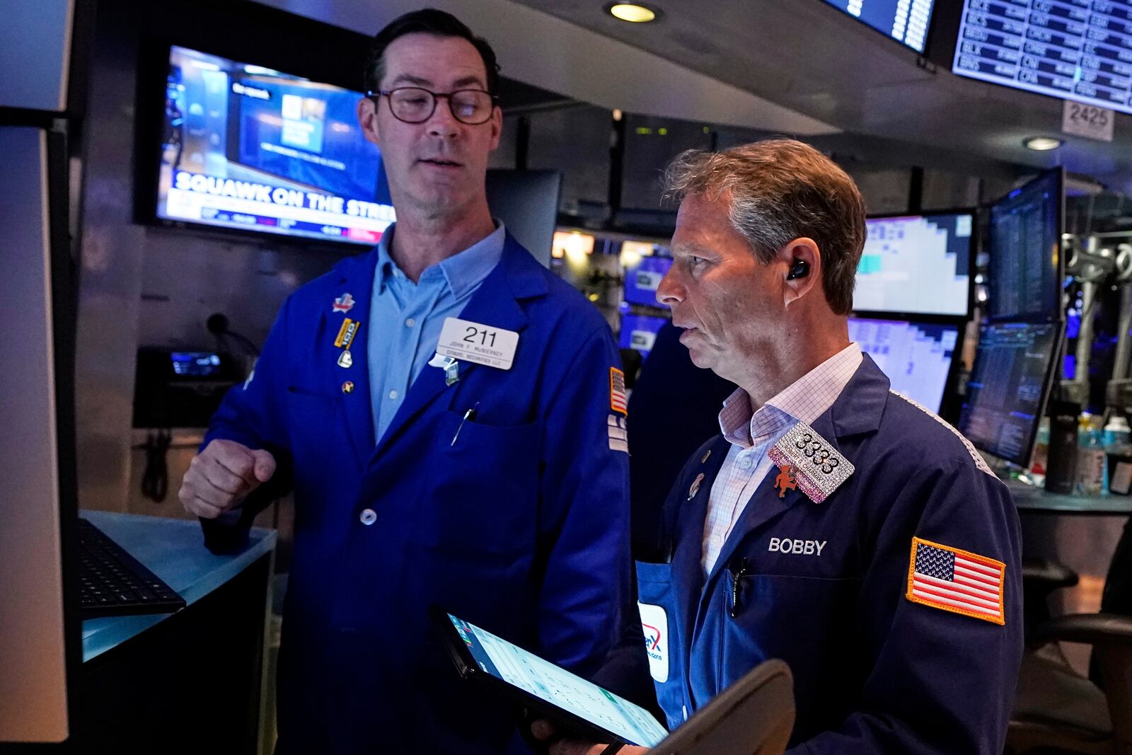 Specialist John McNierney. Left, and trader Robert Charmak work on the floor of the New York Stock Exchange, Wednesday, April 16, 2025. (AP Photo/Richard Drew)