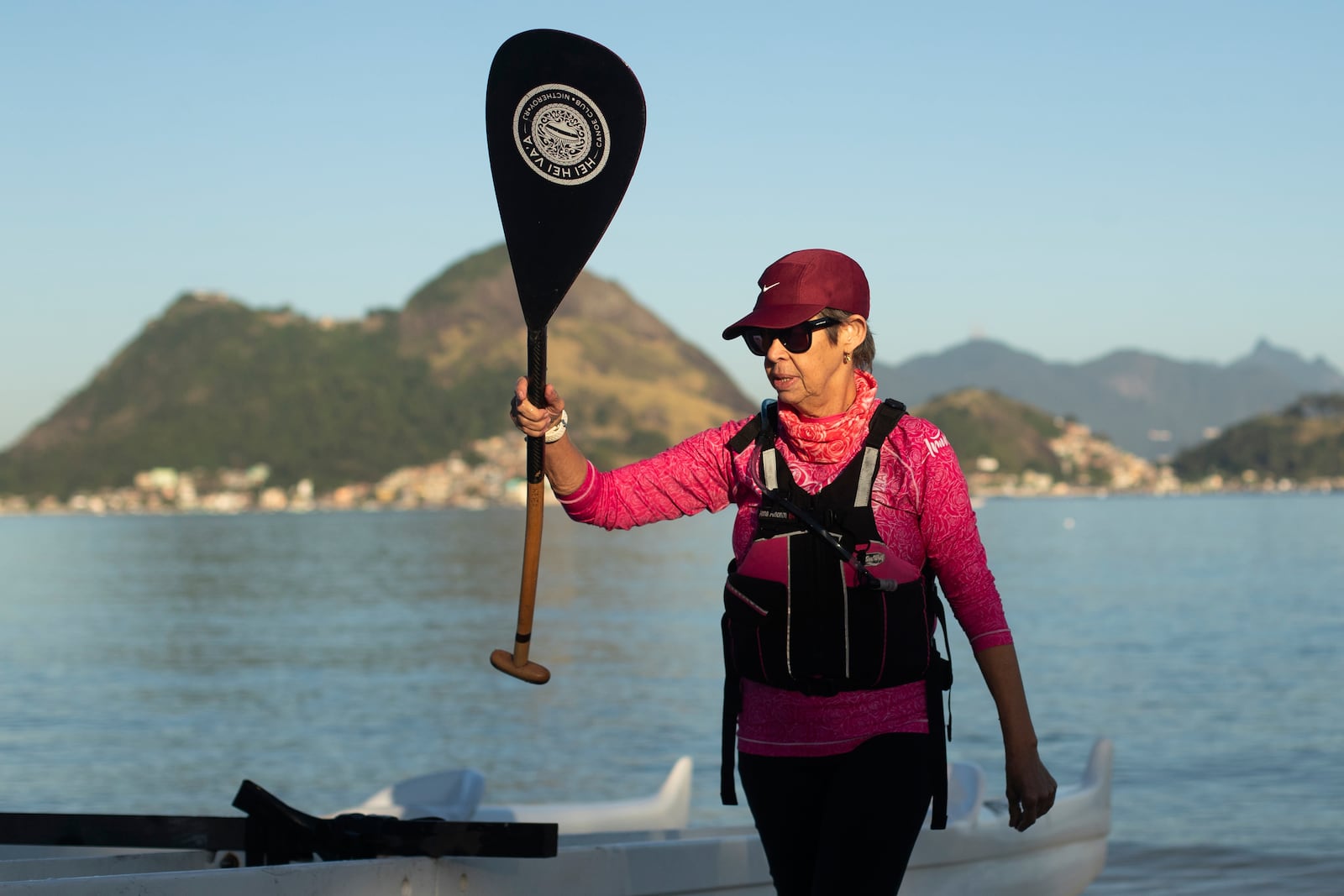 Breast cancer survivor Anna Lucia Amorim, 63, of the Rosas Va'a Hawaiian canoeing team whose members have undergone cancer treatment, gets ready for team training on Charitas Beach in Niteroi, Rio de Janeiro state, Thursday, June 26, 2025. (AP Photo/Bruna Prado)