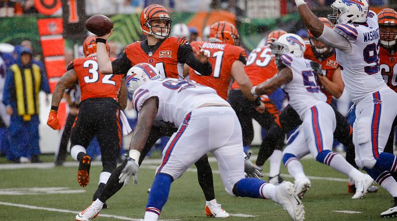 Cincinnati Bengals quarterback Andy Dalton, left, passes in the first half of an NFL football game against the Buffalo Bills, Sunday, Oct. 8, 2017, in Cincinnati. (AP Photo/Frank Victores)