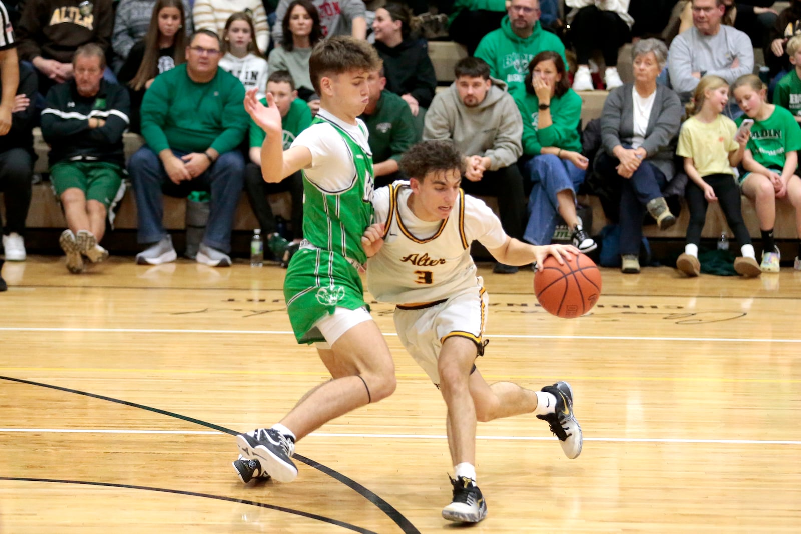 Alter junior Peyton Bakos is defended by Badin senior Eli Stroud. Badin defeated Alter 66-55 in a Greater Catholic League Co-Ed game on Friday, Jan. 30, 2026 in Kettering. STEVEN WRIGHT / STAFF