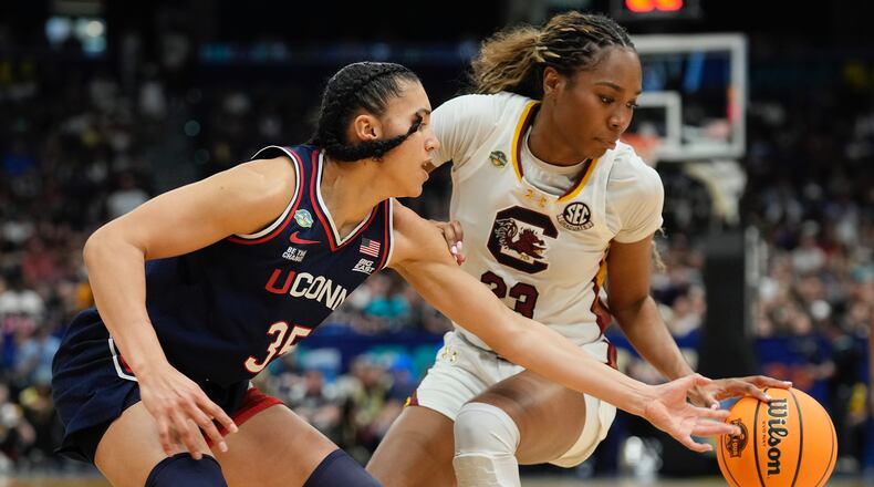 UConn guard Azzi Fudd (35) strips the ball from South Carolina guard Bree Hall (23) during the second half of the national championship game at the Final Four of the women's NCAA college basketball tournament, Sunday, April 6, 2025, in Tampa, Fla. (AP Photo/Chris O'Meara)