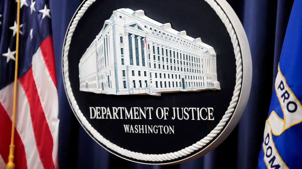 FILE - The logo for the Justice Department is seen before a news conference at the Department of Justice on Aug. 23, 2024, in Washington. (AP Photo/Mark Schiefelbein, File)