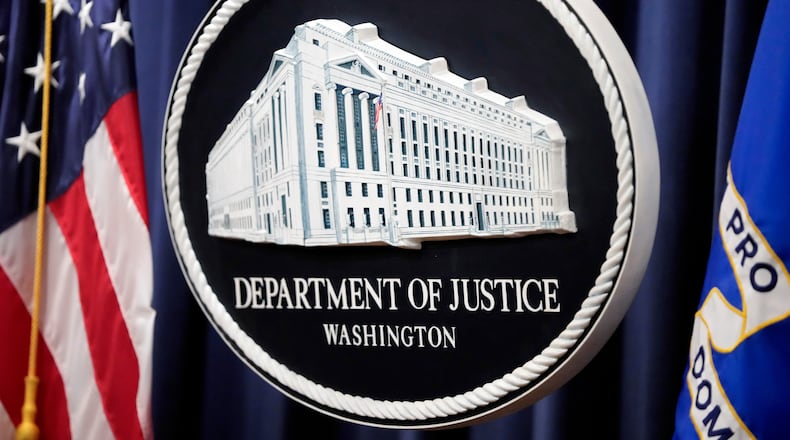 FILE - The logo for the Justice Department is seen before a news conference at the Department of Justice on Aug. 23, 2024, in Washington. (AP Photo/Mark Schiefelbein, File)