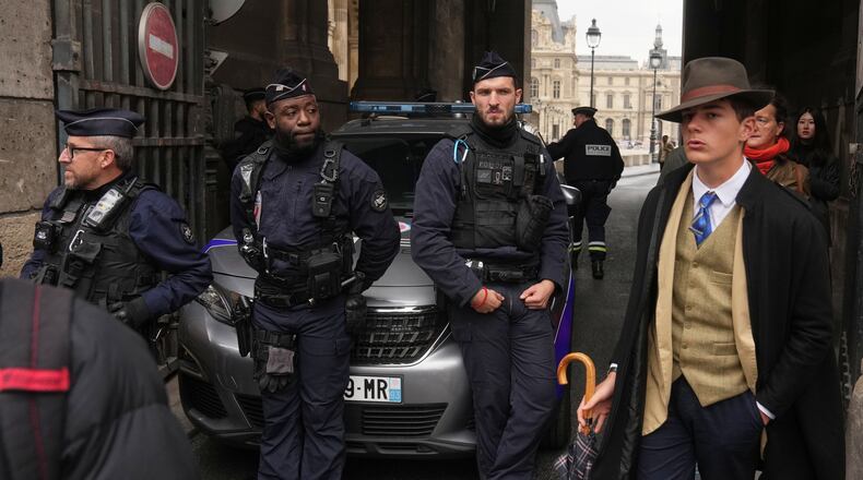 Police officers block an access to the Louvre museum after a robbery Sunday, Oct. 19, 2025, in Paris. (AP Photo/Thibault Camus)