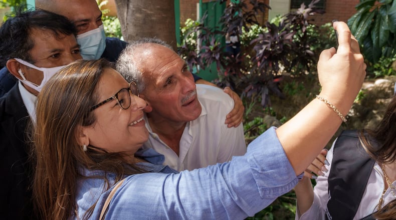 FILE - National Party presidential candidate Nasry Asfura poses for a selfie with a supporter, after voting at a polling station in the general elections in Tegucigalpa, Honduras, Nov. 28, 2021. (AP Photo/Moises Castillo, File)