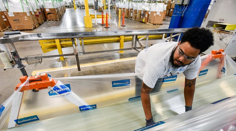 Tryvale Redmond stacks extruded fiberglass products at Deceuninck North America This is their manufacturing facility on Garver Road in Monroe. The company designs, tests and manufactures pvc products used in window and door systems and other extruded pvc and fiberglass products. The facility is celebrating 50 years in operation. NICK GRAHAM/STAFF