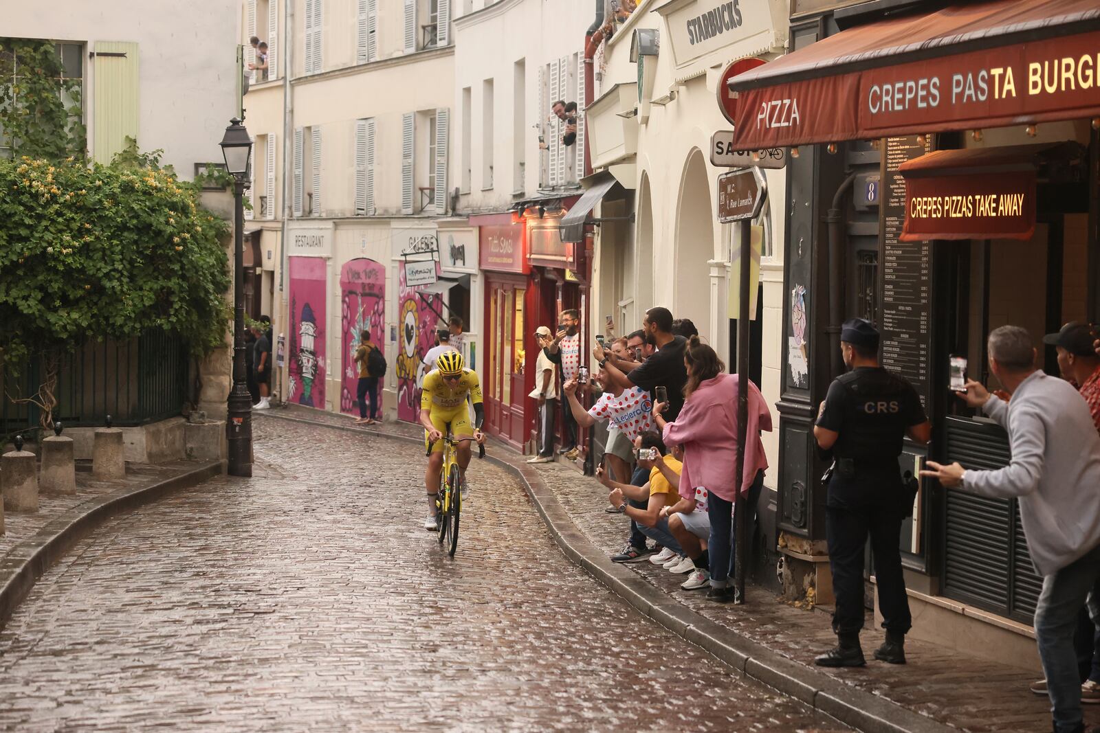 Slovenia's Tadej Pogacar, wearing the overall leader's yellow jersey, pedals at the Place de Tertre in the Montmartre district, during the last stage of the Tour de France cycling race between Mantes-la-Ville and Paris, Sunday, July 27, 2025 in Paris (AP Photo/Thomas Padilla)