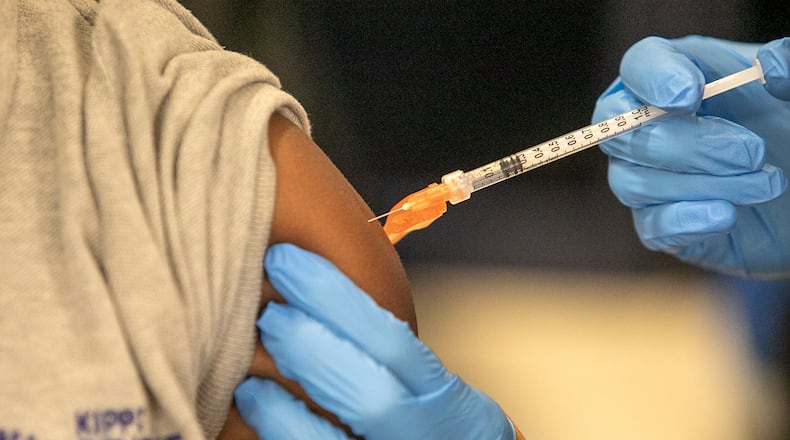 FILE - Medical personnel vaccinate students at a school in New Orleans on Tuesday, Jan. 25, 2022. (AP Photo/Ted Jackson, File)