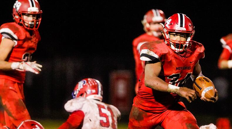 Madison’s Evan Crim eyes the Portsmouth defense during Saturday night’s 26-0 victory for the Mohawks in a Division V, Region 20 playoff game at Brandenburg Field in Madison Township. NICK GRAHAM/STAFF