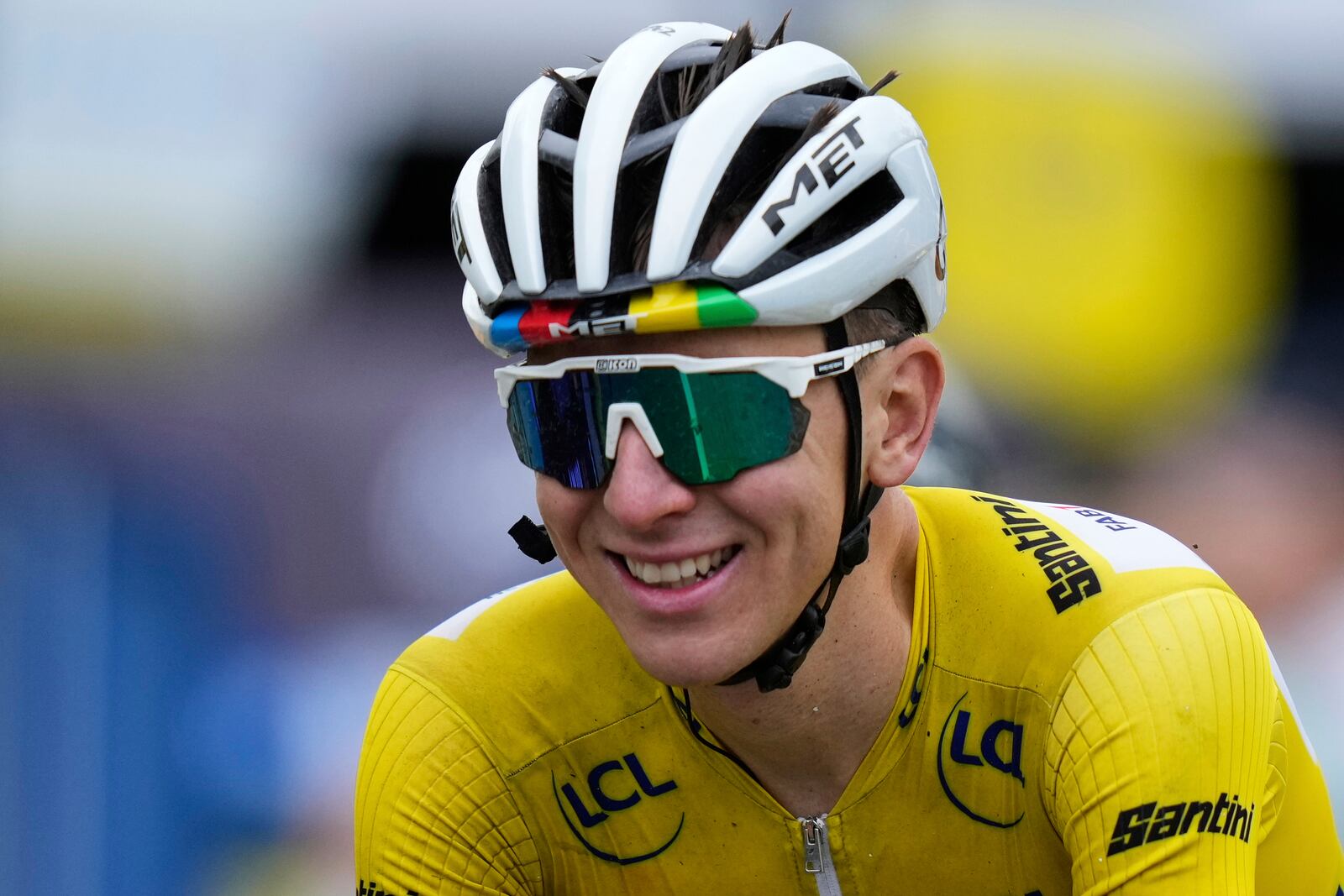 A smiling Slovenia's Tadej Pogacar, wearing the overall leader's yellow jersey, crosses the finish line of the twentieth stage of the Tour de France cycling race over 184.2 kilometers (114.5 miles) with start in Nantua and finish in Pontarlier, France, Saturday, July 26, 2025. (AP Photo/Mosa'ab Elshamy)