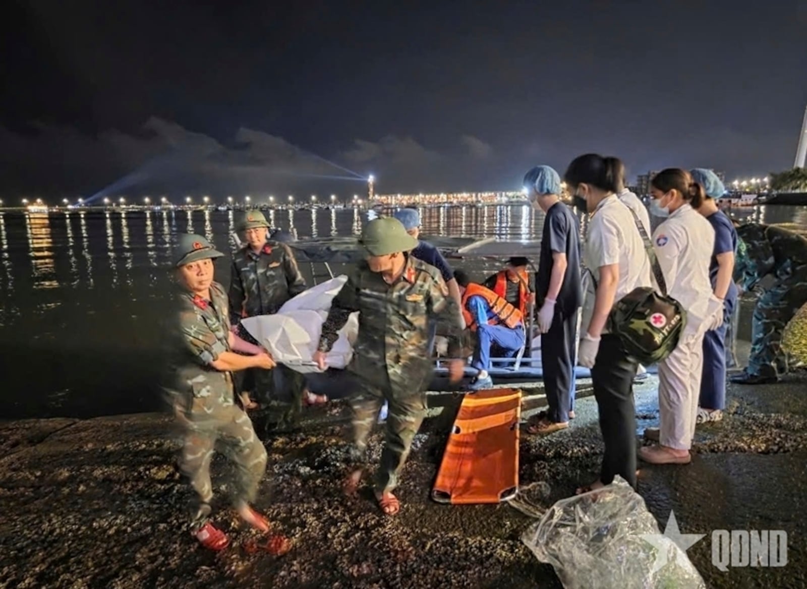 This image from a video provided by QDND shows a body being carried on stretcher after a tourist boat capsized in Ha Long Bay, Vietnam on Saturday, July 19, 2025. (QDND via AP)