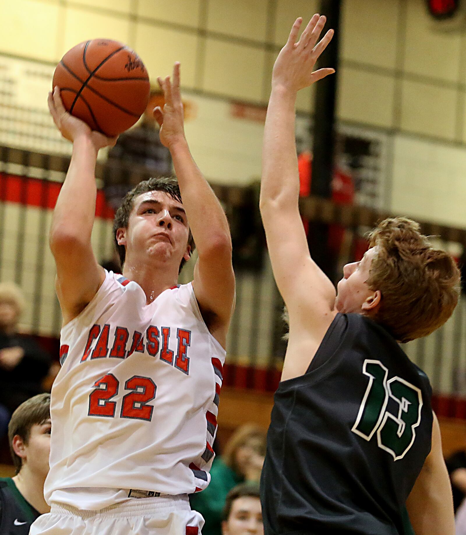 Carlisle forward Justin Flor shoots against Badin wing Justin Pappas during their game at “The Pit” in Carlisle on Feb. 4, 2017. JOURNAL-NEWS FILE PHOTO