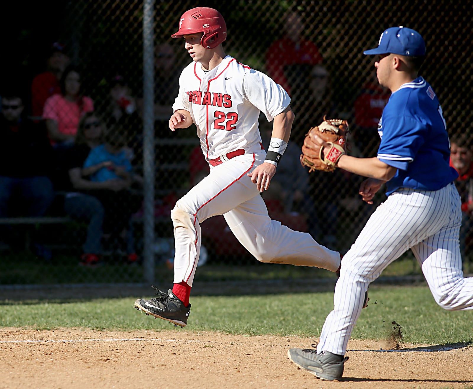 Fairfield’s Brock Mathis scores on a passed ball as Hamilton pitcher Antonio Perez runs in to cover the plate during Sunday’s game at Joe Nuxhall Field in Fairfield. CONTRIBUTED PHOTO BY E.L. HUBBARD
