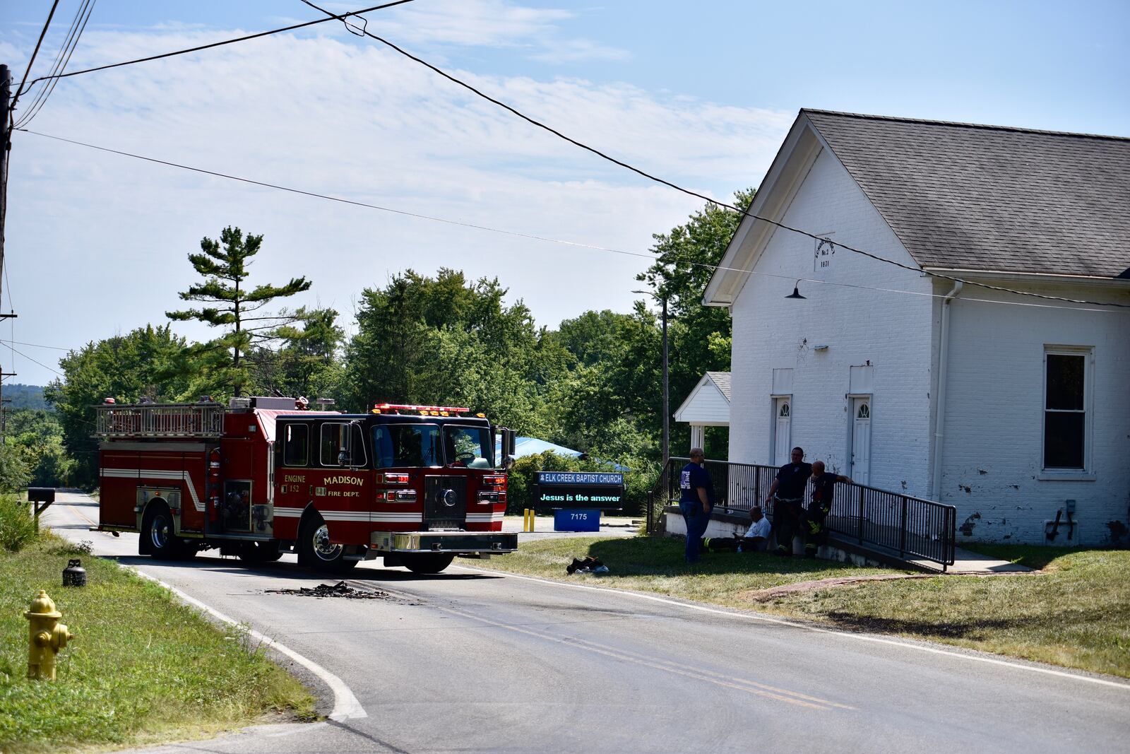 Firefighters battled a blaze in the 7100 block of Elk Creek Road on Sunday, Aug. 4, 2019. A vehicle caught fire at 2:39 p.m near Elk Creek Baptist Church, and the flames spread to nearby brush, according to emergency dispatchers. NICK GRAHAM / STAFF