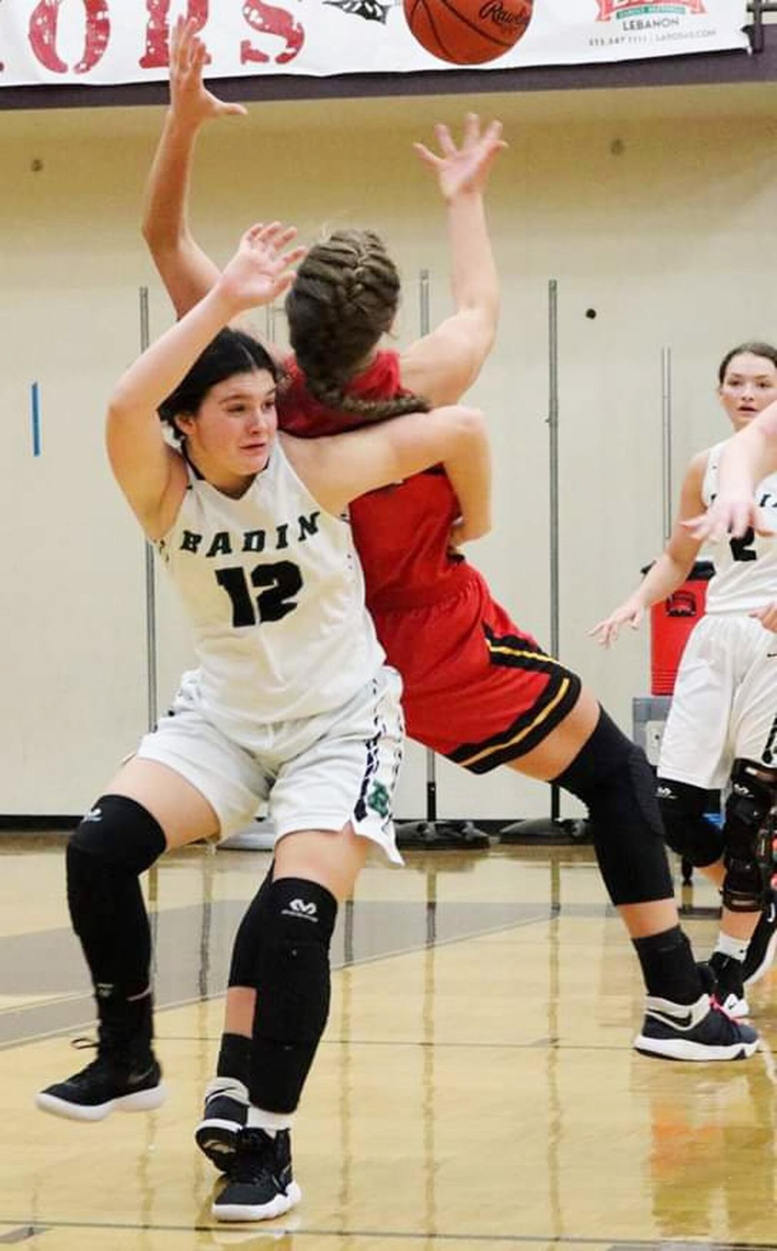 Badin’s Emma Adams (12) and Fenwick’s Emily Adams get tangled up during Tuesday night’s Division II sectional game at Lebanon. Fenwick won 53-46. CONTRIBUTED PHOTO BY TERRI ADAMS