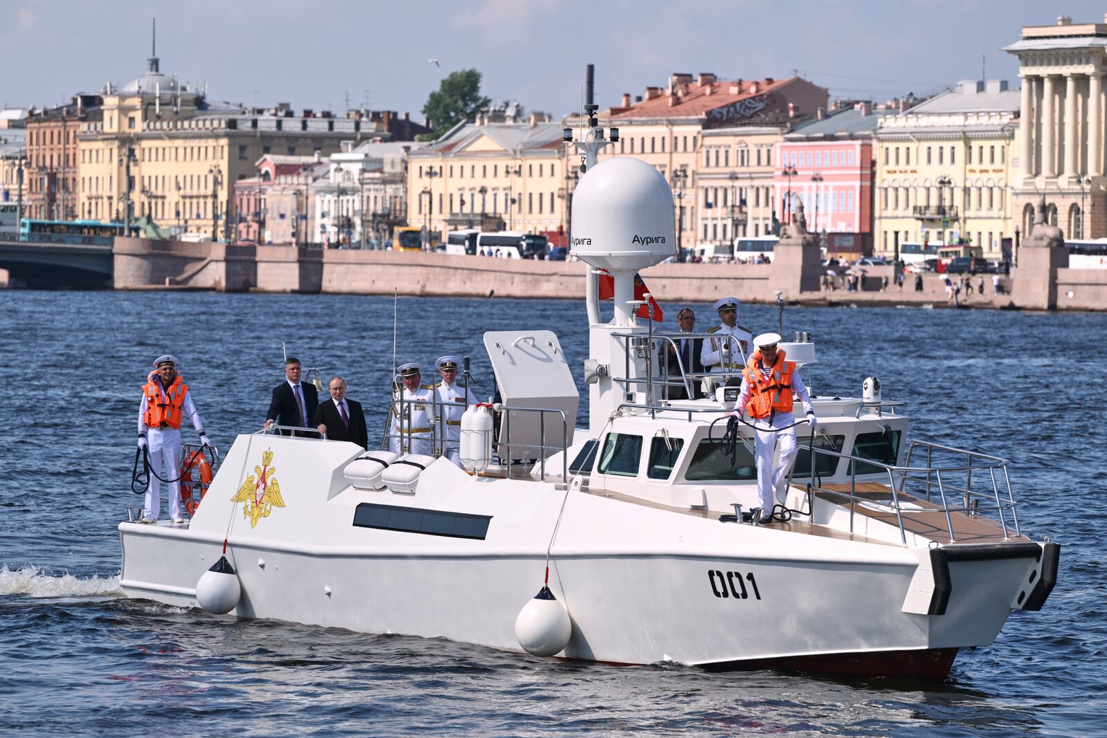 Russian President Vladimir Putin, third from left, stands aboard the Raptor boat during his visit to St. Petersburg on Navy Day, Russia, on Sunday, July 27, 2025. (Alexei Danichev, Sputnik, Kremlin Pool Photo via AP)