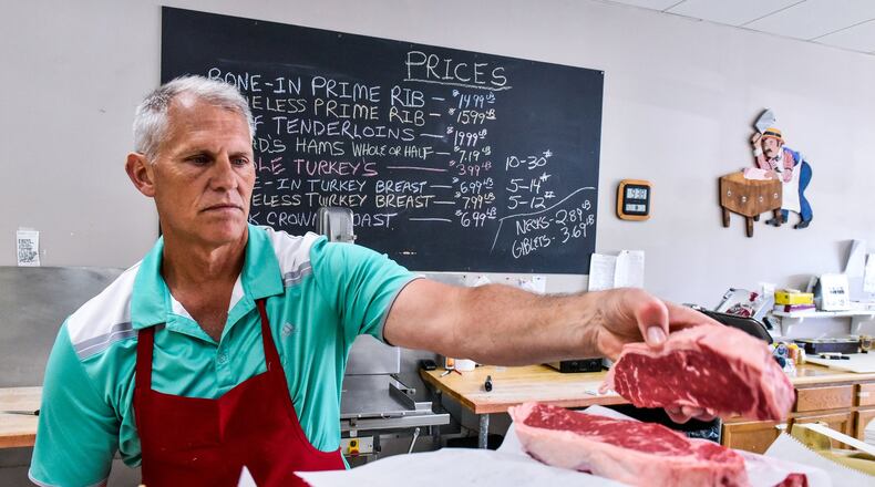 Steve Overberg, owner of Steve’s Meat & Deli in West Chester Twp., prepares an order of steaks for a customer Friday, May 25. Memorial Day weekend is the unofficial start of grilling season and is a major holiday that drives sales, including meat sales, at local grocery stores. NICK GRAHAM/STAFF