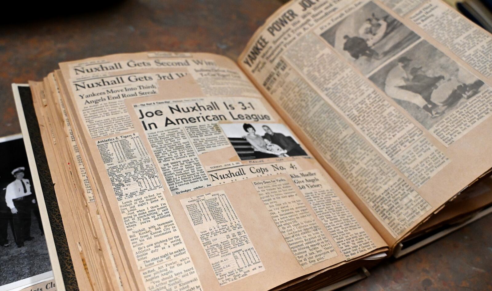 The Nuxhall family is working with the Lane Libraries and Miami University to archive more than 50 scrap books, mostly of the late Joe Nuxhall's baseball career. More than 30 have already been digitized, which will eventually be made available on the Lane Library's website. The most of the physical copies will be displayed at the Nuxhall Foundation's Hope Center, a year-round indoor facility for special needs athletes. Pictured is one of the dozens of scrapbooks assembled by Donzetta Nuxhall, the late wife of Joe Nuxhall. MICHAEL D. PITMAN/STAFF