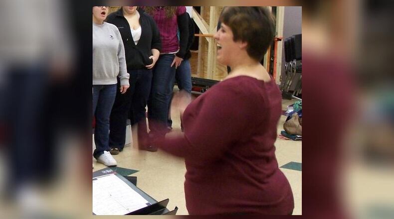 Former Lebanon City Schools teacher and high-school choir director Kristi L. Ross, 36, of Centerville has been indicted on a felony theft charge as well as misdemeanor counts of misuse of credit cards, tampering with records and falsification. She is pictured directing a district choir.