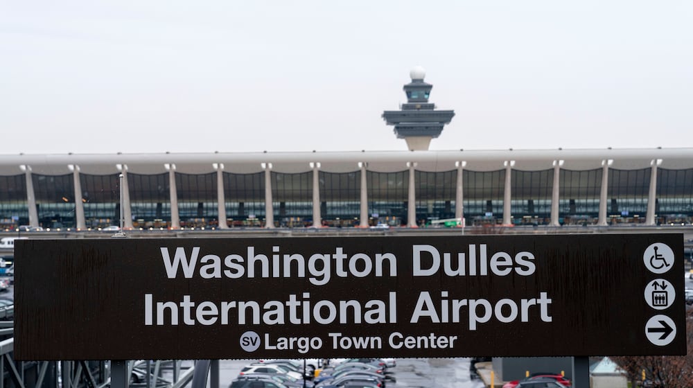 FILE - A sign of Washington Dulles International Airport station is seen during the opening of new Silver Line Extension at Washington Dulles International Airport, in Chantilly, Va., Nov. 15, 2022. (AP Photo/Jose Luis Magana, File)